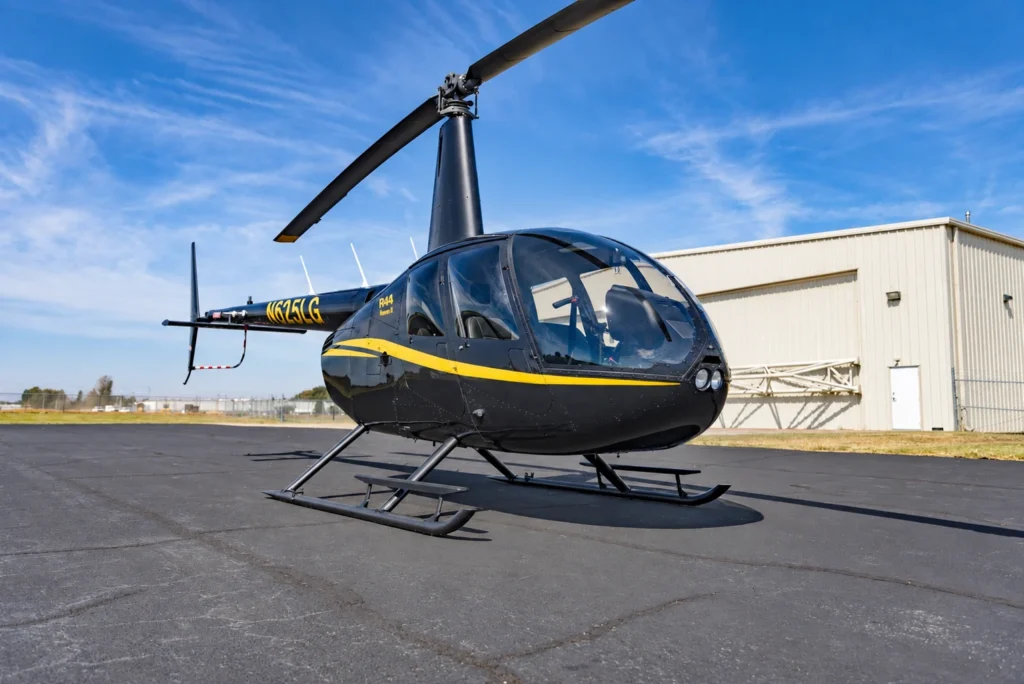 Black and yellow Robinson R44 Raven II helicopter at the Jackson flight school