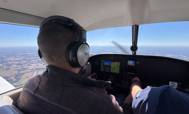 Pilot wearing a headset at the controls during a Right Rudder flight lesson